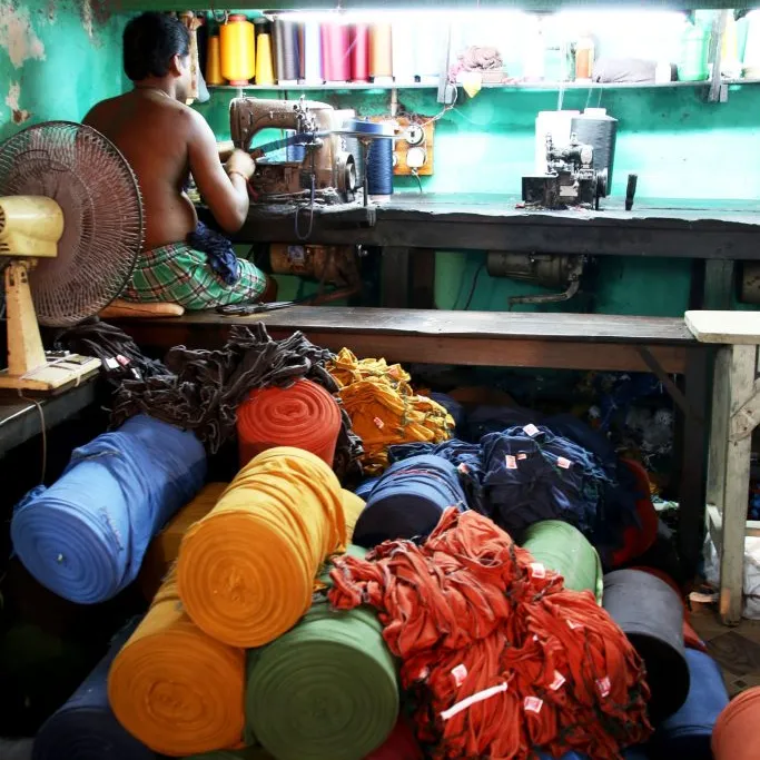 Rolls of Fabric at their Feet